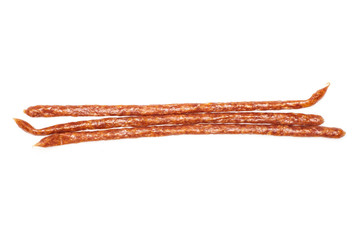 Group of three whole spicy salami stick tyrolini flatlay isolated on white background