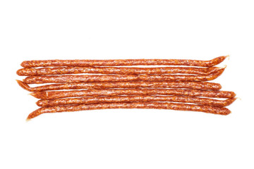 Group of seven whole spicy salami stick tyrolini flatlay isolated on white background