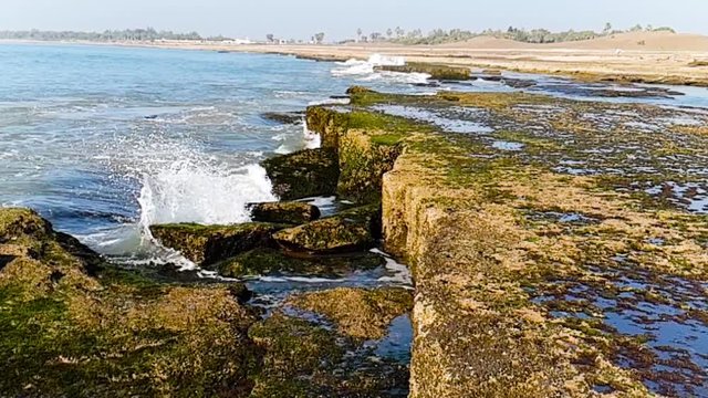 Slow motion shot of waves crashing into rocks on Nagoa beach in daman gujarat