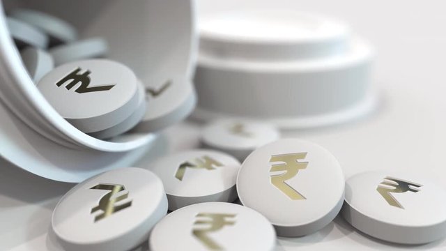 Close-up shot of pills with stamped Indian rupee INR symbol on them. Expensive drugs or financial remedy conceptual animation