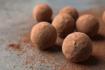 Fototapeta na wymiar Delicious raw chocolate truffles on grey background, space for text