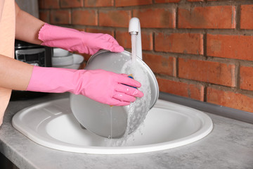 Woman washing modern multi cooker in kitchen sink, closeup