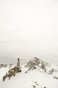 A man stading on granite spire in Little Cottonwood Canyon, Salt Lake City, Utah.