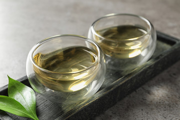 Glass cups of freshly brewed oolong tea on table, closeup