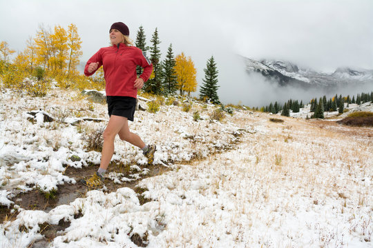 A woman trail running  on Molas Pass near Silverton, Colorado.