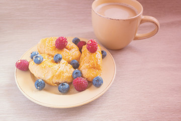 fresh juicy summer berries raspberry and blueberry with drops of honey in a natural beige cotton cloth. 