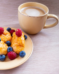 fresh juicy summer berries raspberry and blueberry with drops of honey in a natural beige cotton cloth. 