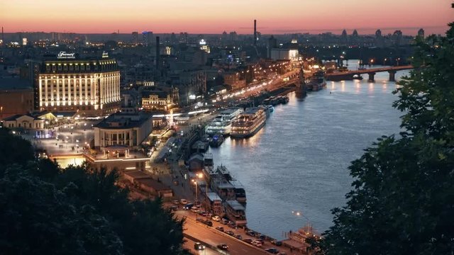 Beautiful view on the Dnieper river, Post square, River station, Harbour Bridge and Naberezhno-Kreschatitska street in capital of Ukraine - Kiev. Evening panorama of Podol in Kyiv