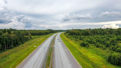 Fototapeta na wymiar 11059_Aerial_shot_of_the_roads_with_the_forest_on_the_side.jpg