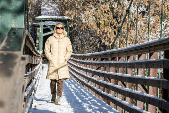 Adult woman walking alone across bridge, Durango, Colorado, USA