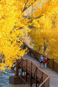A mother and daughter walking on the Animas River Trail in Durango, Colorado.