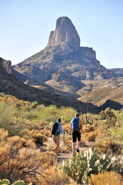 Man and woman backpackers hike on the popular Peralta Trail in the Superstition Wilderness Area, Tonto National Forest near Phoenix, Arizona November 2011.