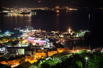 The Budva city - the modern part is among the mountain ranges. Panorama of the Budva Riviera at night. Montenegro, Europe