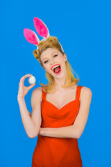 Easter. Rabbit. Bunny. Egg hunt. Spring. Holiday. Happy girl with rabbit ears holds white eggs. Easter concept. Woman with bunny ears. White eggs. Bunny girl.