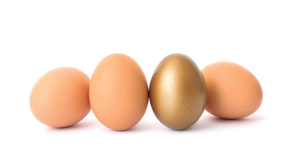 Golden egg among others on white background
