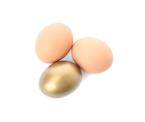 One golden egg among others on white background, top view