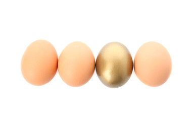 One golden egg among others on white background, top view