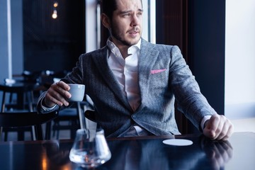 Business man drinking coffee in a cafe - coffee time.