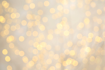 Blurred view of golden Christmas lights as background. Bokeh effect