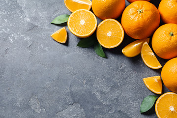 Flat lay composition with fresh oranges on grey background. Space for text