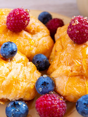 fresh juicy summer berries raspberry and blueberry with drops of honey in a natural beige cotton cloth. 