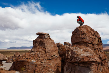 A young man plays on the rocks in the Atacama Desert. The Salar de Uyuni is the world's largest salt flat and home to one of the largest deposits of lithium in the world. The communities surrounding this region could potentially benefit greatly or suffer with the development and extraction.