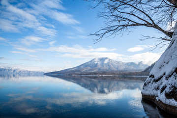 Mount Tarumae reflected in shallow waters of Lake Shikotsu