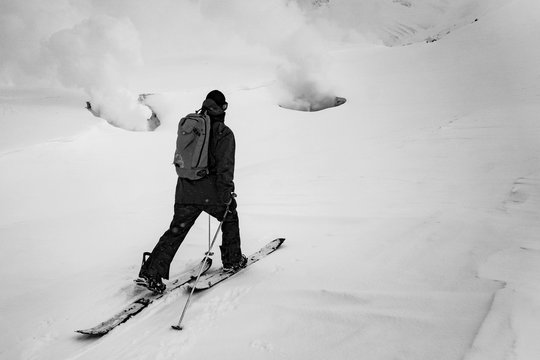 A snowboarder touring up to the fume holes on Mt. Asahi in Japan