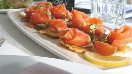 In the beautiful restaurant, the chef (cook) has prepared many different dishes and serves them on the table and many different glasses of wine and other different drinks. Concert of: Banquet, Chef.