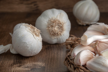 Close-up of garlic over twisted rope and dark wood background