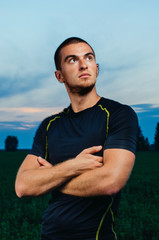 portrait of a boy in a sports Jersey. a guy with strong hands. shooting in the Park of the athlete