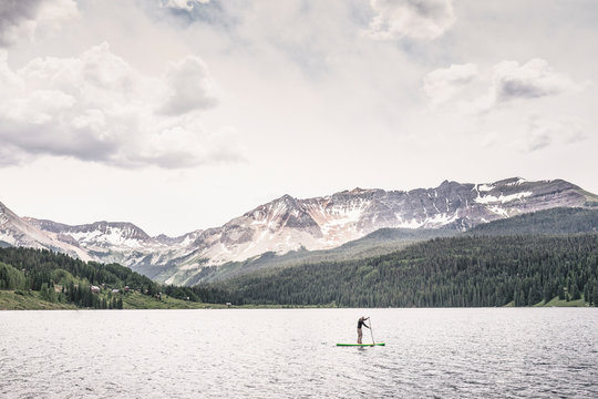 Man paddleboarding on Trout Lake, Telluride, Colorado, USA