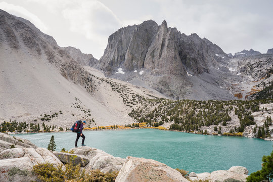 Female hiker standing over Second Lake below Temple Crag