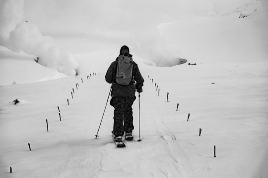 A snowboarder touring up to the fume holes on Mt. Asahi in Japan