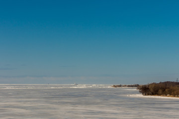 Tolbukhin lighthouse in the Gulf of Finland and Fort Reef. Ice hummocks.