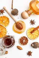 Wooden spoon for honey, herbs, nuts and spices on a white background. Top view.