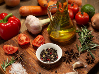 Fresh vegetables and spices on wooden background