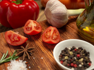 Fresh vegetables and spices on wooden background