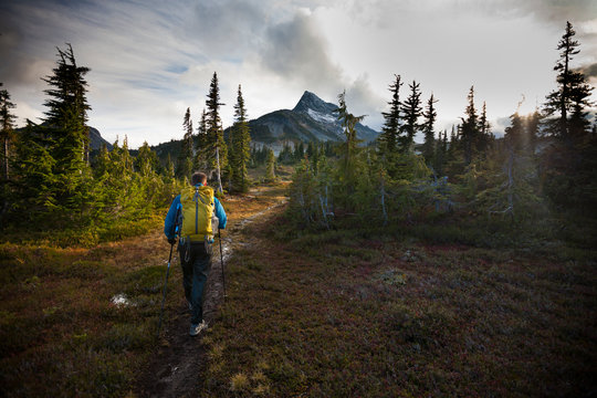 Rear View Of Man With Backpack Hiking Towards Jim Kelly Peak