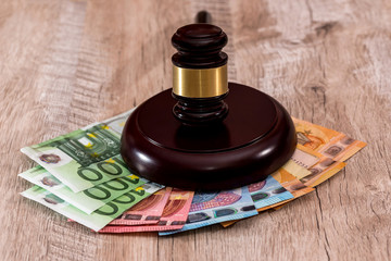 Judge's gavel on stack of euro banknotes