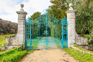 Private property blue wrought iron gate at National Forest of Carnoet, Finistere, Brittany, France 