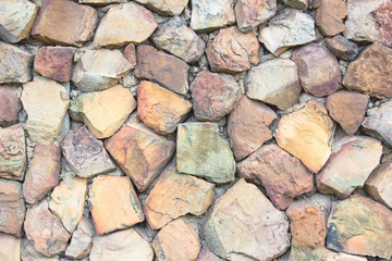 Seamless brown pattern of decorative grey slate stone wall surface of modern style design decorative uneven cracked realmasonry wall.