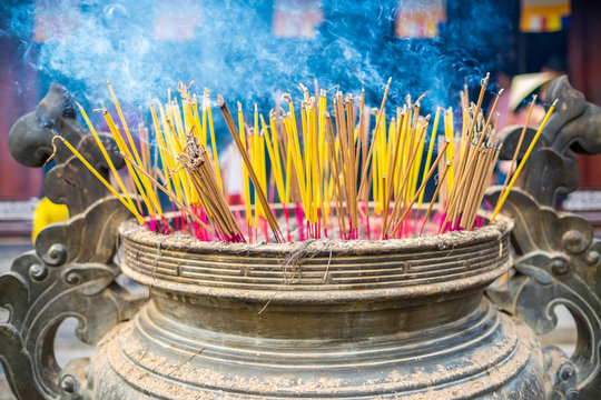 Burning incense sticks at Thien Mu Pagoda, Hue, Vietnam