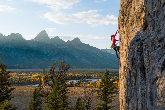 Female rock climber climbing in Teton Range, Wyoming, USA