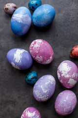 Colorful painted Easter eggs on dark background.