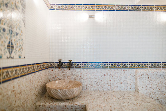 Interior of Turkish sauna, classic Turkish hammam at spa center. Steam room at spa, relaxation and resort health care center interior. Decorated in golden colors. Eastern hammam.
