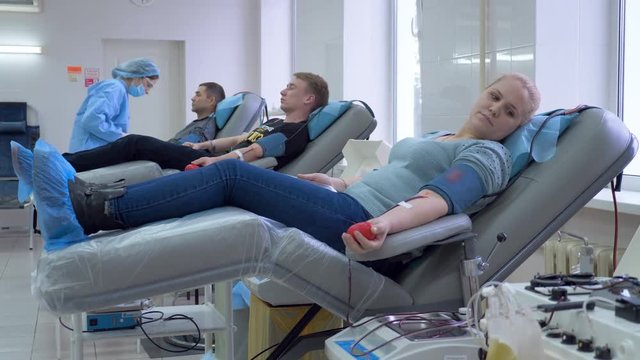 One doctor checks blood donors in a donation center, charity work.