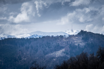 Mountain Dobratsch with radio antenna on snowy summit in spring