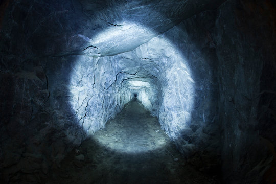 Tunnel in cave illuminated by flashlight, Inspiration Point, Yosemite National Park, California, USA
