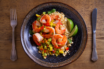Shrimps with cauliflower, mango avocado, red paprika pepper and lime. overhead, horizontal